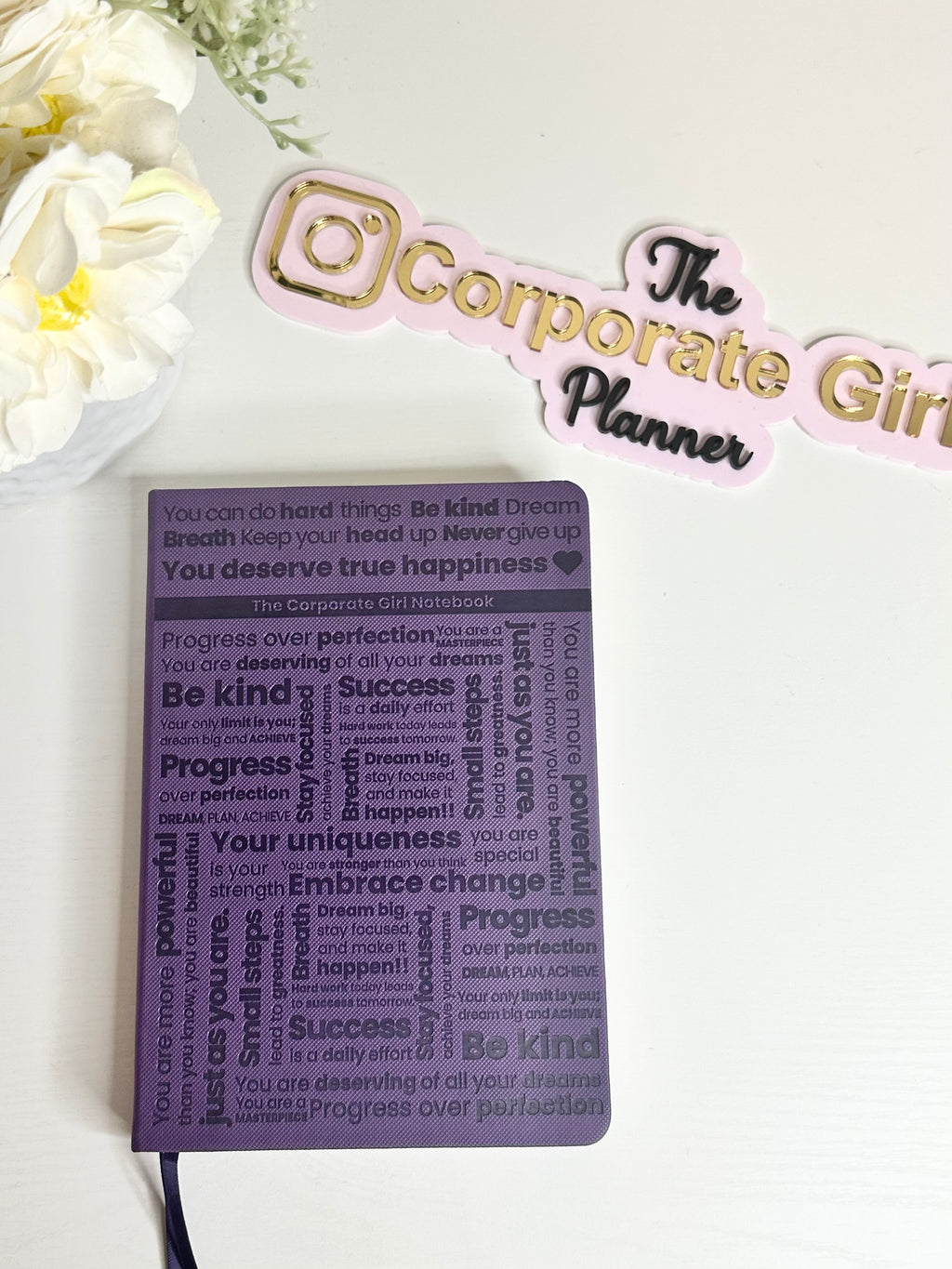 Purple embossed notebook with holographic edges and dotted paper with pocket in the back. 