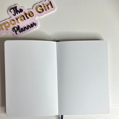 Purple A5 notebook with holographic edges and embossed cover with positive affirmations. Bulleted paper with pocket on the back.