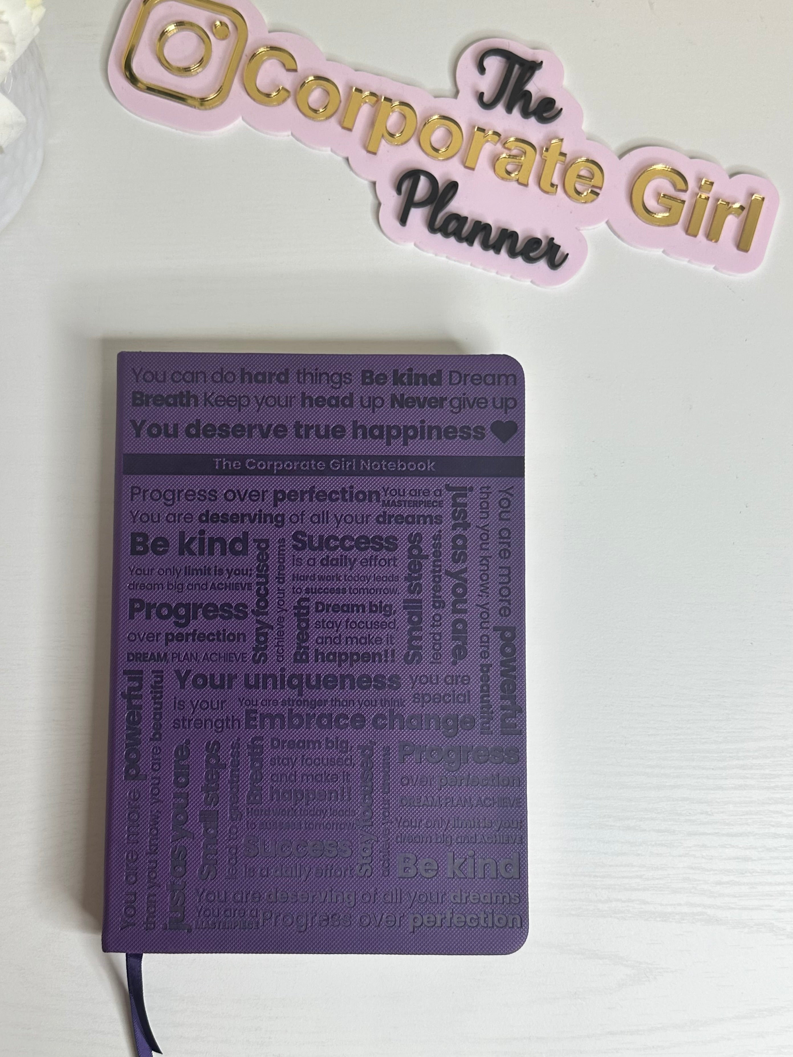 Purple A5 notebook with holographic edges and embossed cover with positive affirmations. Bulleted paper with pocket on the back.