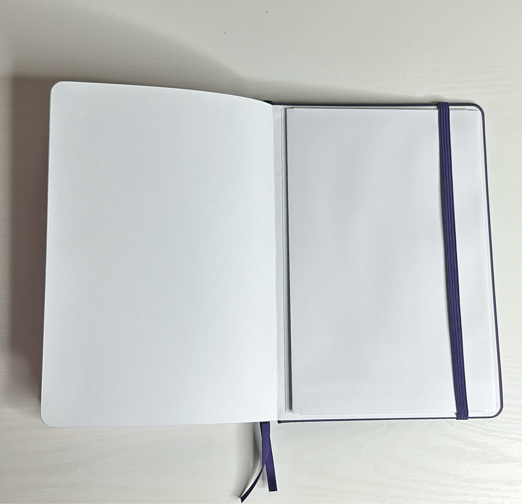Purple A5 notebook with holographic edges and embossed cover with positive affirmations. Bulleted paper with pocket on the back.