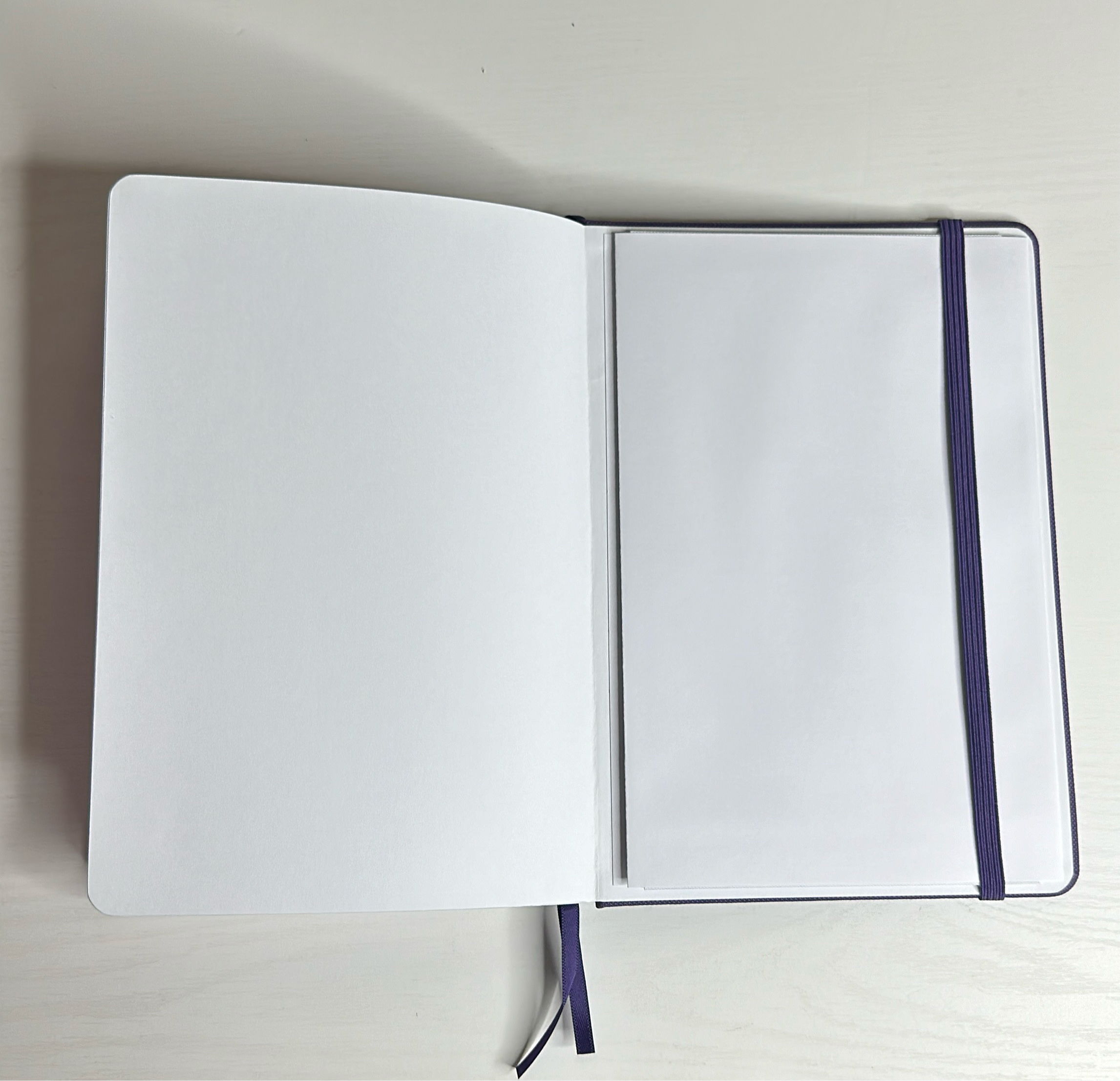 Purple A5 notebook with holographic edges and embossed cover with positive affirmations. Bulleted paper with pocket on the back.