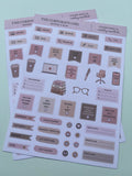 Two sheets of cute office-themed stickers on a pale mint green background. The stickers feature illustrations of coffee cups, notebooks, eyeglasses, and text labels in muted shades of pink, beige, and brown.