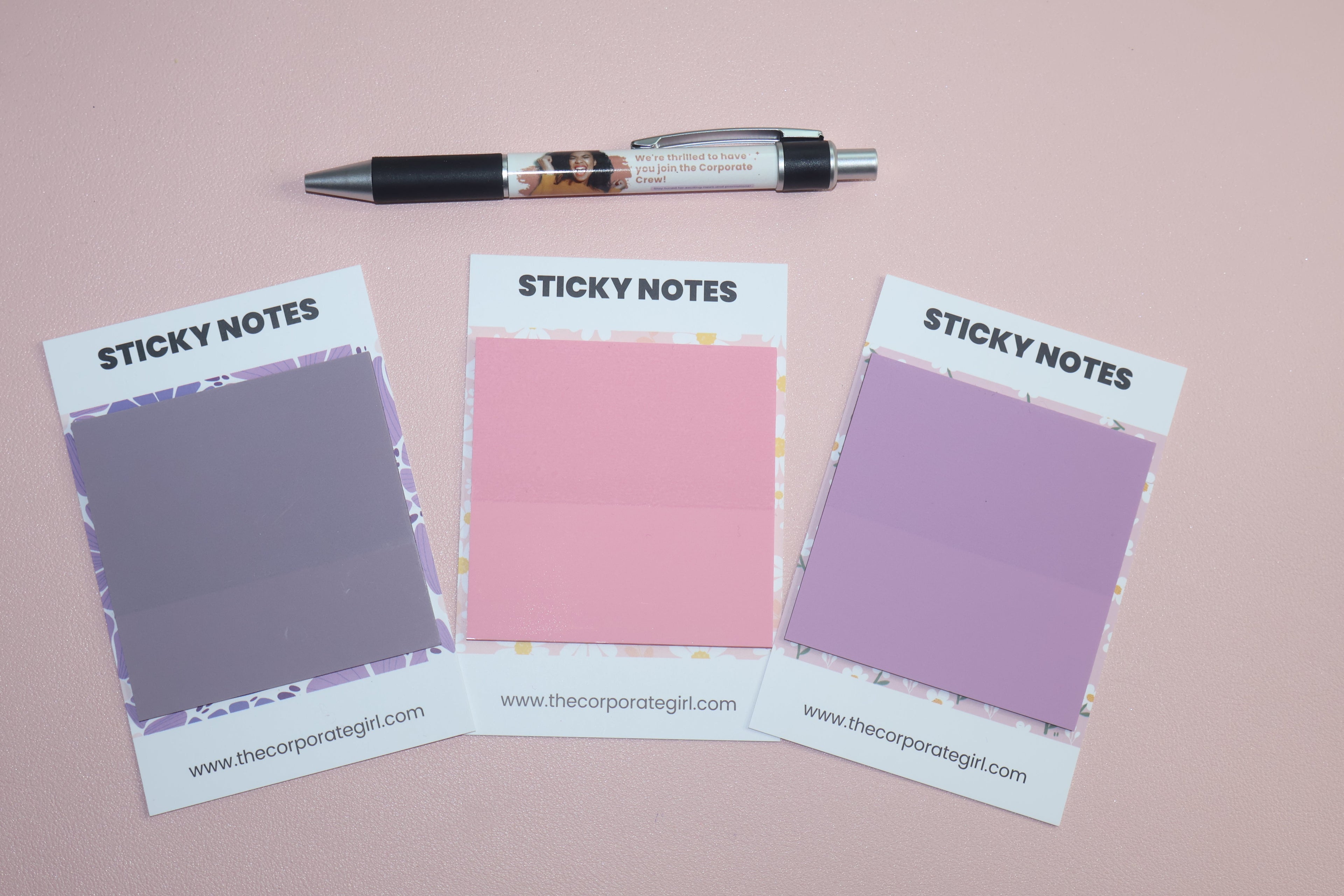 Three sticky notes ranging from purple to pink from The Corporate Girl Planner. 